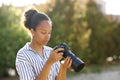 Black photographer checking result on camera