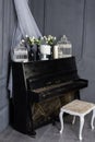 Black piano and chair in the gray room Royalty Free Stock Photo