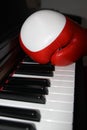 Black piano with red and white boxing gloves