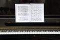 Black piano with sheet music