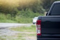 Black pick up car beside road.