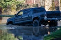 A big truck driving through a flood