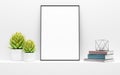 Black picture frame mock up and green potted plants on white
