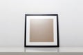 black picture frame on a table. Stylish photoframe with passe-partout Royalty Free Stock Photo