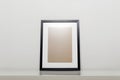 black picture frame on a table. Stylish photoframe with passe-partout Royalty Free Stock Photo