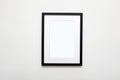 black picture frame on white wall. photoframe with passe-partout Royalty Free Stock Photo