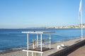 A black pigeons sits atop a Poste de Secours, or First Aid Station on the empty beach of the Bay of Angels on the French Riviera Royalty Free Stock Photo