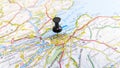 A black pin stuck in Edinburgh on a map of Scotland