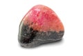 Black and pink colored rhodonite gemstone, isolated on white background. Rounded smooth surface.