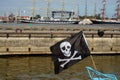 Black Pirate Flag flying form the top of a Mast on a boat Royalty Free Stock Photo
