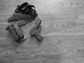 Black pistol in holster and magazines with weathered wood backdrop