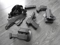 Black pistol in holster and magazines with weathered wood backdrop