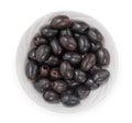 Black pitted olives in bowl isolated on white background, top view, close up Royalty Free Stock Photo