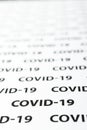Black plain text on white paper about coronavirus outbreak. Covid-19