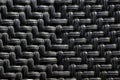 Black plastic basketwork pattern process of weaving or sewing pliable materials. Royalty Free Stock Photo