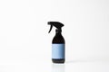 Black plastic bottle with trigger-spray and color label on a white background Royalty Free Stock Photo