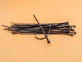 Black plastic cable ties on an orange background. Royalty Free Stock Photo