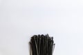 Bundle of Black Cable Ties on White Background Royalty Free Stock Photo