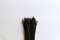 Bundle of Black Cable Ties on White Background Royalty Free Stock Photo