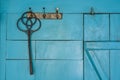 Black plastic carpet beater hangs on blue wall Royalty Free Stock Photo