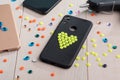 Black plastic case decorated with yellow bead heart