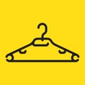 Black plastic clothes hanger, isolated on yellow background Royalty Free Stock Photo