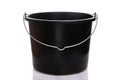 Black plastic construction bucket with a metal thin handle on a white isolated background Royalty Free Stock Photo