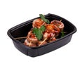 A black plastic container that is filled with meat on skewers inside Royalty Free Stock Photo