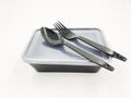 Black Plastic food container with spoon and fork Royalty Free Stock Photo