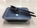 Black plastic food container with spoon and fork Royalty Free Stock Photo