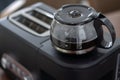 Black plastic and glass automatic espresso machine or coffeemaker top view. Modern Drip Coffee Pot