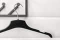 Black plastic hanger on white wall background