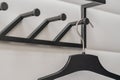 Black plastic hangers on white wall background Royalty Free Stock Photo