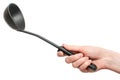 Black plastic kitchen ladle in hand isolated on white background Royalty Free Stock Photo