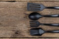 Black plastic kitchen set skimmer, spade of frying pan on wooden