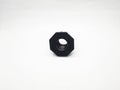 Black plastic octagonal threaded bushing isolated on a white background closeup Royalty Free Stock Photo