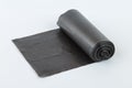 Black plastic polyethylene garbage bags roll isolated over the white background. Royalty Free Stock Photo