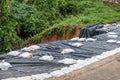 Black plastic with sandbag covered on collapsed road
