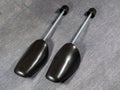 Black plastic shoe trees. Shoe stretcher on a gray background Royalty Free Stock Photo