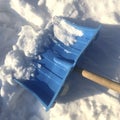 Blue plastic shovel for snow removal, snowdrift Royalty Free Stock Photo
