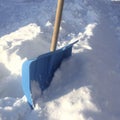 Blue plastic shovel for snow removal, snowdrift Royalty Free Stock Photo
