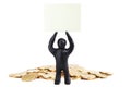 Black plasticine man with poster on his head isolated on a white background. Pile of money. Make money. Heap of coins Royalty Free Stock Photo