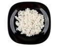 Black plate with boiled white rice isolated on white Royalty Free Stock Photo