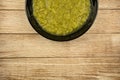 a black plate of fresh vegetable green cream soup served on rustic background Royalty Free Stock Photo