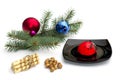 black plate with red cake, a fir-tree branch, cookies and nutlets