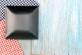 Black plate on tablecloth on wood table background Royalty Free Stock Photo