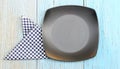 Black plate on tablecloth on wood table background Royalty Free Stock Photo