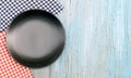 Black plate on tablecloth on wood table background Royalty Free Stock Photo