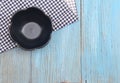 Black plate on tablecloth on wood table background Royalty Free Stock Photo