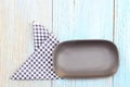 Black plate on tablecloth on wood table background Royalty Free Stock Photo